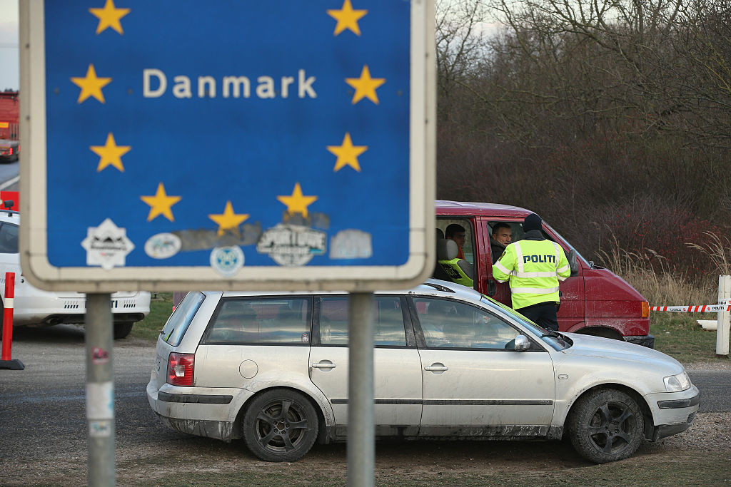 PADBORG, DENMARK - JANUARY 06:  Danish police conducting spot checks on incoming traffic check the documents of the passengers of a van arriving from Germany at the A7 highway border crossing on January 6, 2016 near Padborg, Denmark. Denmark introduced a 10-day period of passport controls and spot checks yesterday on its border to Germany in an effort to stem the arrival of refugees and migrants seeking to pass through Denmark on their way to Sweden. Denmark reacted to border controls introduced by Sweden the same day and is seeking to avoid a backlog of migrants accumulating in Denmark. Refugees still have the right to apply for asylum in Denmark and those caught without a valid passport or visa who do not apply for asylum are sent back to Germany.  (Photo by Sean Gallup/Getty Images)