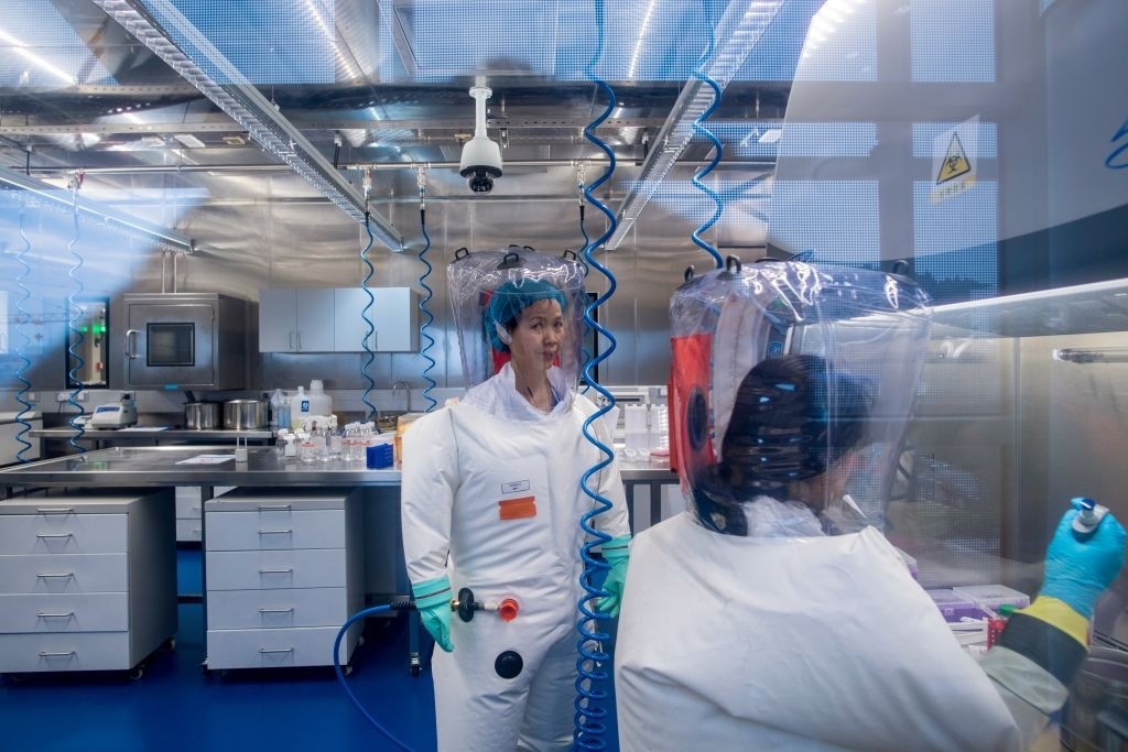 Chinese virologist Shi Zhengli (L) is seen inside the P4 laboratory in Wuhan, capital of China's Hubei province on February 23, 2017. - The P4 epidemiological laboratory was built in co-operation with French bio-industrial firm Institut Merieux and the Chinese Academy of Sciences. (Photo by Johannes EISELE / AFP) (Photo by JOHANNES EISELE/AFP via Getty Images)