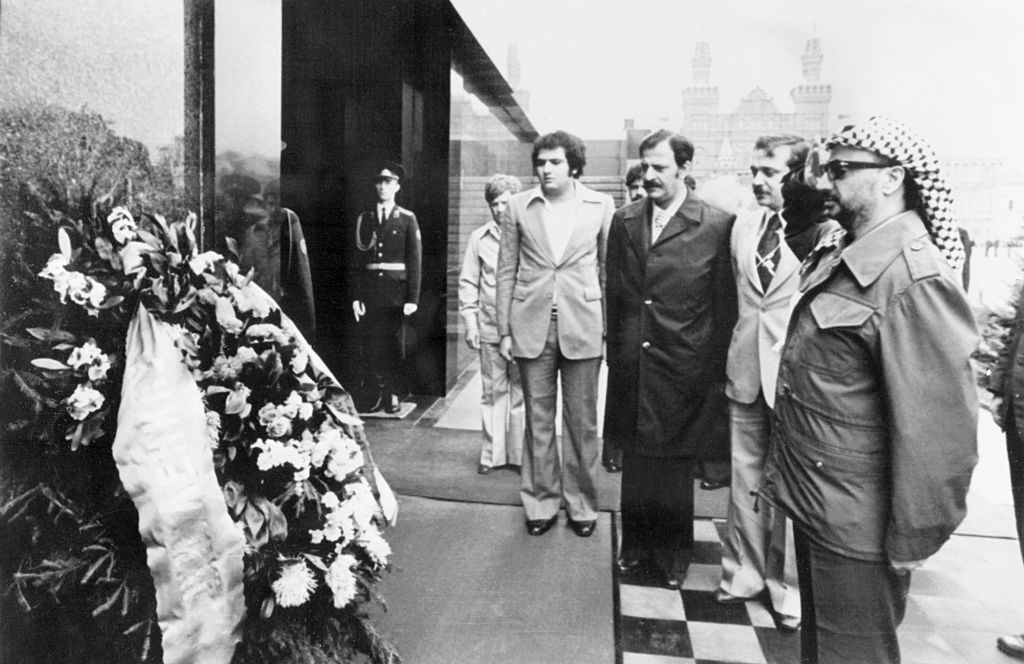 The Palestine Liberation Organization (PLO) Executive committee president Yasser Arafat (R) pays respect in front of Lenin Mausoleum where he laid a wreath during his 12th visit in Moscow in August 1977. (Photo credit should read STF/AFP via Getty Images)