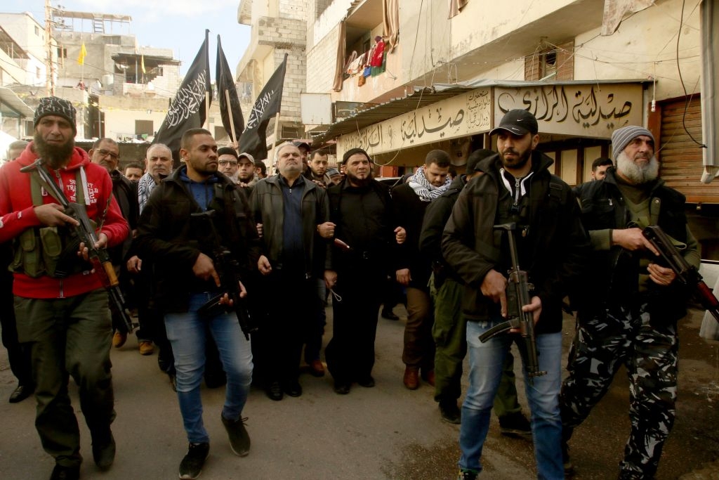 Armed Palestinians take part in a rally organised in Ain el-Helweh, Lebanon's largest Palestinian refugee camp, near the southern coastal city of Sidon, to protest against the US-brokered proposal for a settlement of the Middle East conflict, on January 31, 2020. - President Donald Trump's long delayed Middle East peace plan won support in Israel but was bitterly rejected by Palestinians facing possible Israeli annexation of key parts of the West Bank. The plan gives the Jewish state a US green light to annex key parts of the occupied West Bank. (Photo by Mahmoud ZAYYAT / AFP) (Photo by MAHMOUD ZAYYAT/AFP via Getty Images)