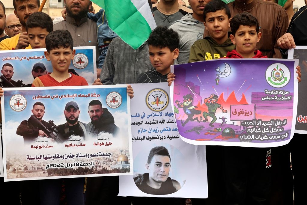 Supporters of the Palestinian Hamas and Islamic Jihad militant group rally after Friday prayers in Khan Yunis The Southern Gaza Strip, on April 8, 2022, lifting placards expressing support of the Al-Aqsa mosque, the Tel Aviv attacker, and three Islamic Jihad militants killed by Israeli security forces days ago when they came under fire during a raid in the West Bank. - Israel's Premier gave security agencies "full freedom" of operation to curb surging violence, after the latest deadly attack saw a Palestinian gunman kill two men in a popular nightlife area. (Photo by SAID KHATIB / AFP) (Photo by SAID KHATIB/AFP via Getty Images)