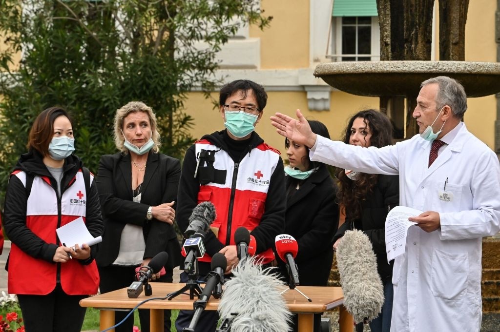 Italian Francesco Vaglia medical director for infectious diseases of Spallanzani hospital (R) speaks next to the team of chinese doctors during the press conference about Covid-19 situation, outside the Spallanzani Hospital in Rome in central Rome on March 14, 2020, during the COVID-19 outbreak caused by the novel coronavirus. (Photo by Andreas SOLARO / AFP) (Photo by ANDREAS SOLARO/AFP via Getty Images)