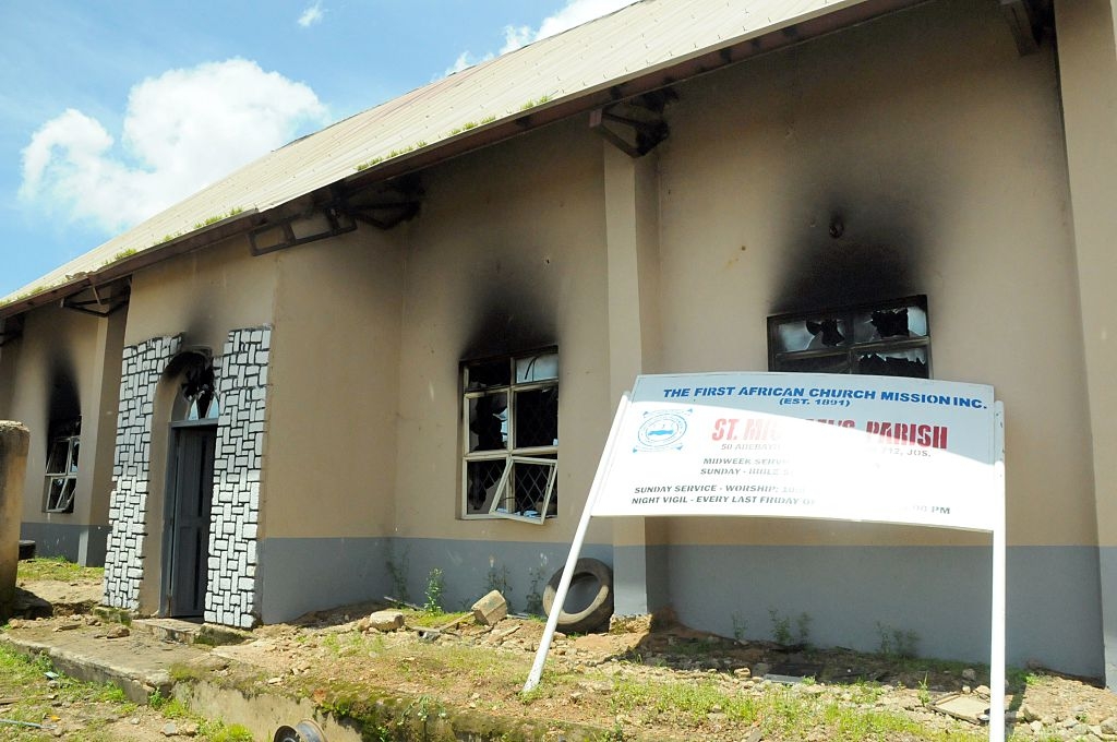 The burnt First African Church Mission of Jos is pictured on July 6, 2015 in the central Nigerian city of Jos, Plateau State, after a twin bomb blasts killed at least 44 people the day before, following a wave of mass casualty attacks blamed on Boko Haram militants. The blasts happened within minutes of each other at a shopping complex and near a mosque in the religiously divided capital of Plateau state, which the rebels have targeted before. The bombings took the death toll from raids, explosions and suicide attacks to 267 this month alone and to 524 since Muhammadu Buhari became president on May 29, according to an AFP count. AFP PHOTO (Photo credit should read -/AFP via Getty Images)